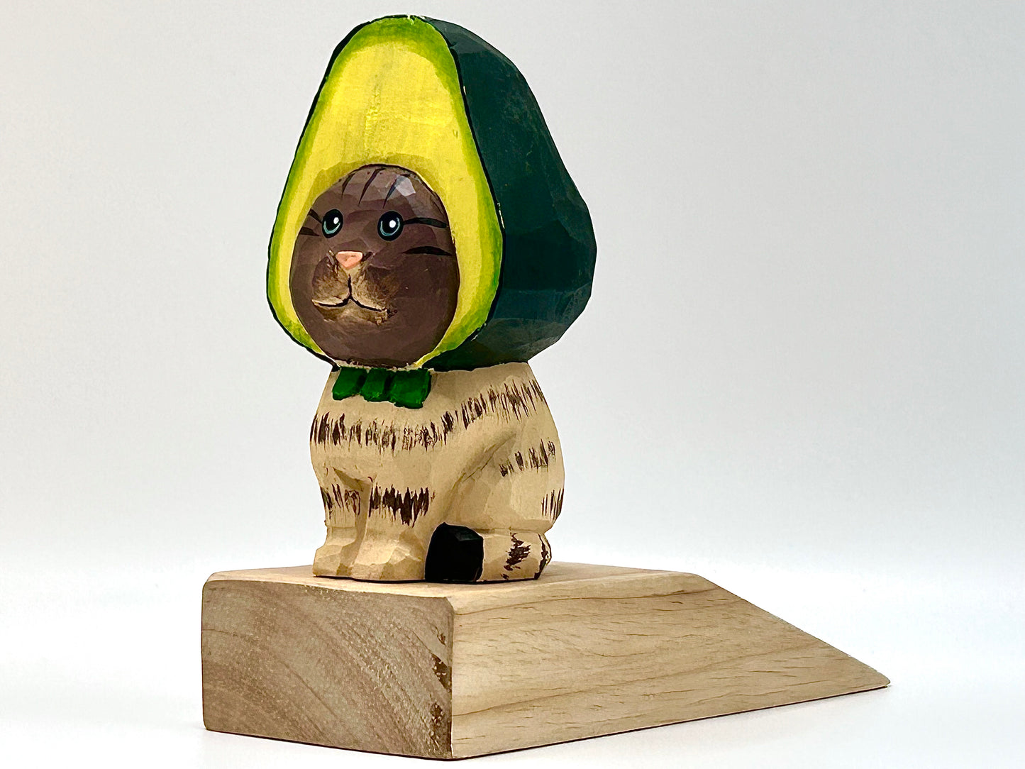 Whimsical Wood Doorstop: Playful Cat with Avocado Hat Accent